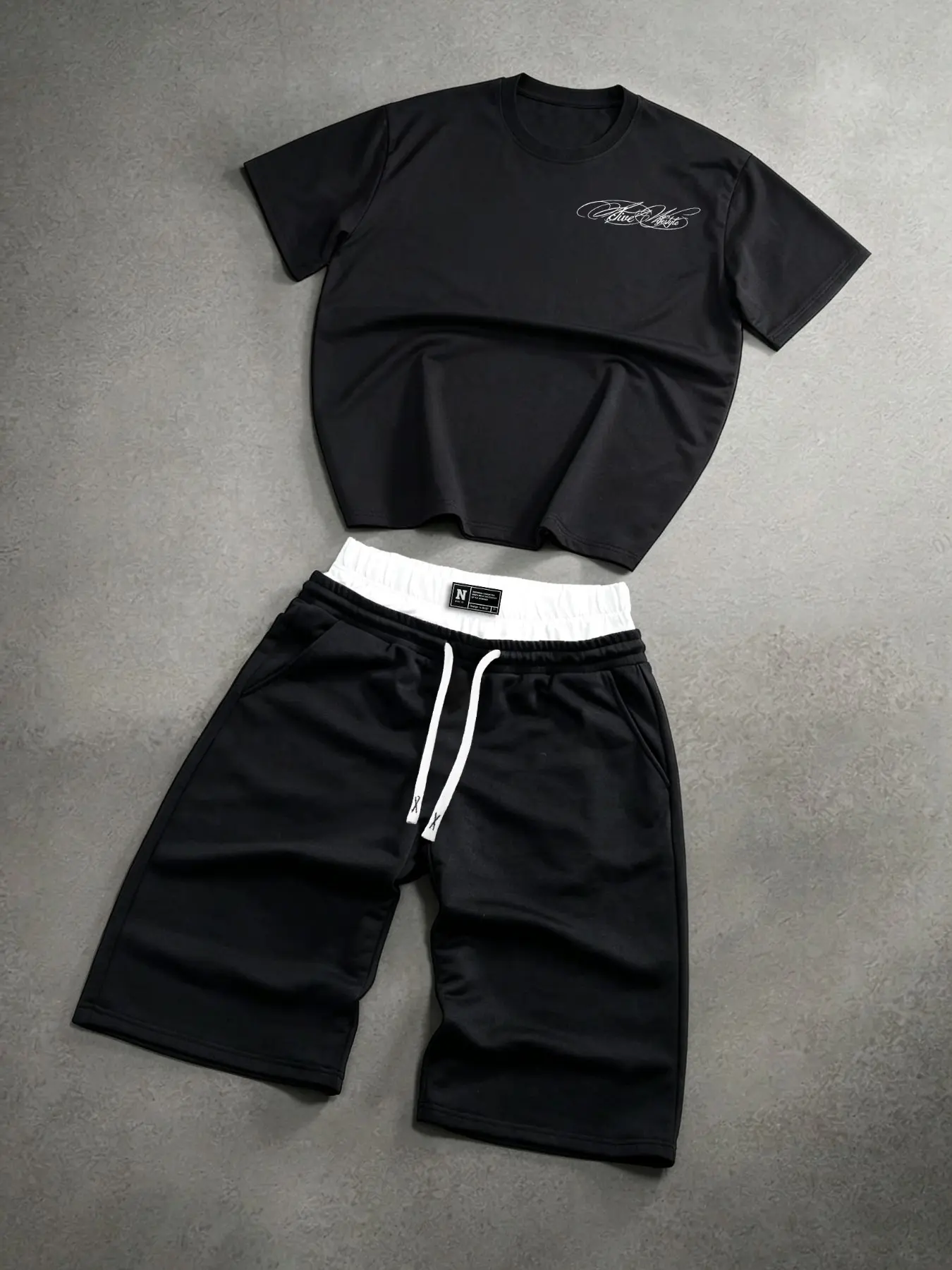 Black Minimalist Men Co Ord Short Set Skin Friendly Sweat Wicking Wrinkle Resistant Short Sleeve Script Graphic Tee Single Waistband With Contrast White Inner Lining Drawstring Sweat Shorts Relaxed Straight Leg With Pockets Summer Vacation Loungewear Trav