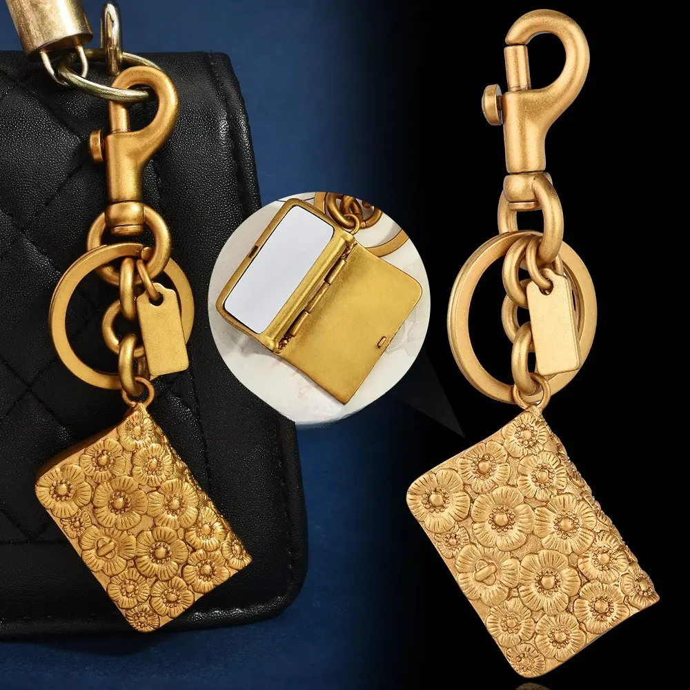 Luxury Vintage Metal Keychain With Embossed Flower Pattern Glossy Mirror Panel Available In Gold And Silver Tone Compact Portable Light Design For Daily Carry Holiday Gift Giving Minimalist Elegant Decorative Bag Accessory