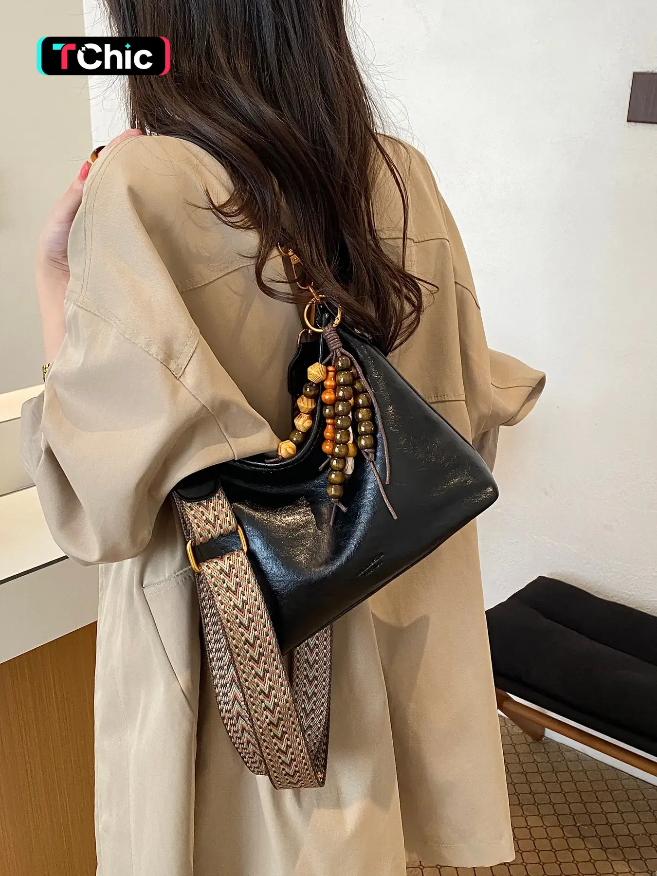 Vintage lazy style pleated crossbody fashion bag; crescent underarm bag; interchangeable shoulder strap with detachable wooden bead charm; open-top slouchy body; versatile for commuting and travel; casual shoulder and handbag.