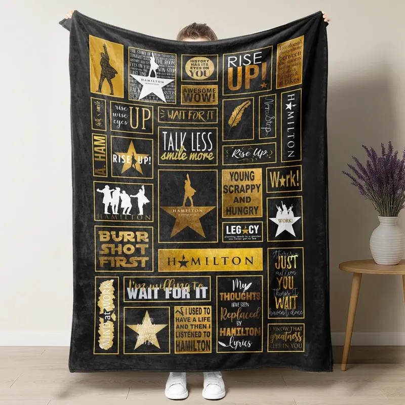Hamilton Musical flannel blanket ideal for bedrooms sofas and offices featuring a logo patchwork pattern suitable for all seasons