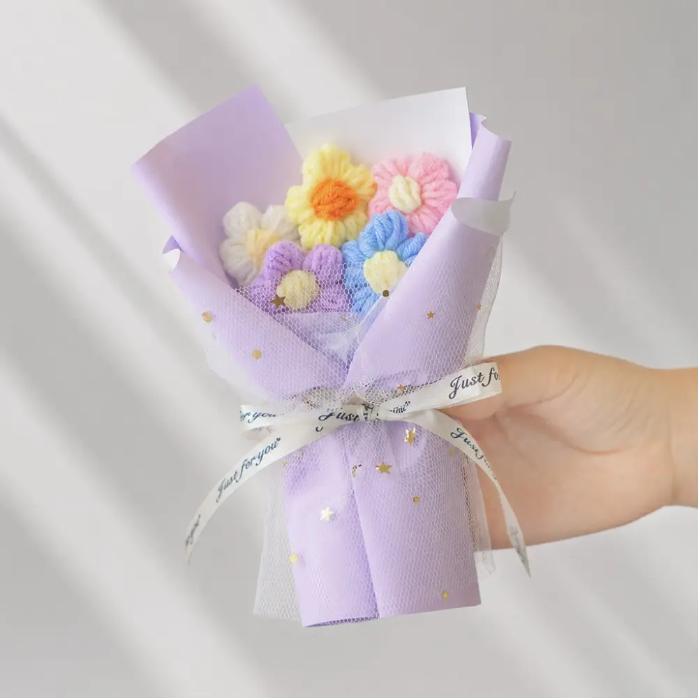 A carefully handmade bouquet of five knitted flowers with tulle puffs, a small gift for the holidays