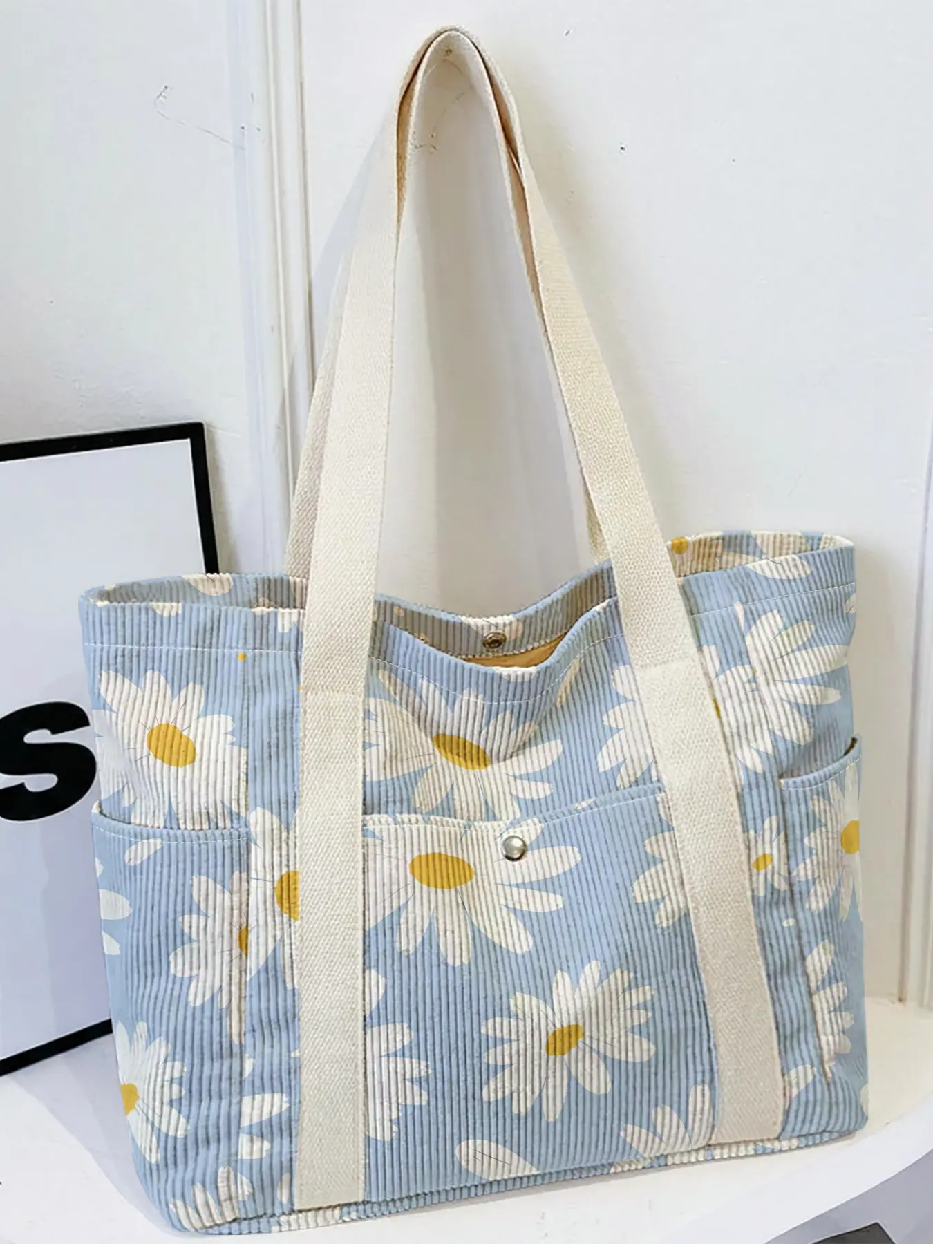 Women's tote bag, 2D Print of Scattered Daisies on Light Blue Background, Multi-pocket travel tote with wide strap, fit for daily, school and shopping.