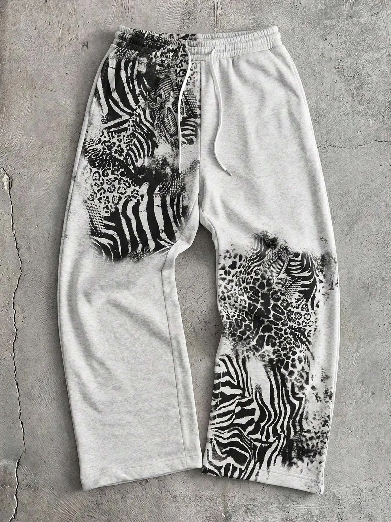 Gray loose wide-leg sweatpants with mixed zebra and leopard animal print patchwork, featuring an elastic drawstring waist and side pockets. Casual Streetwear Pants Perfect for street style, hip-hop parties, casual everyday wear, and weekend outings.
